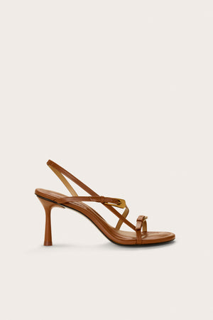 Side profile of a brown strappy heel that features two gold buckle details and a slingback strap.