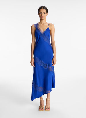 Model facing the camera in the blue asymmetric midi dress