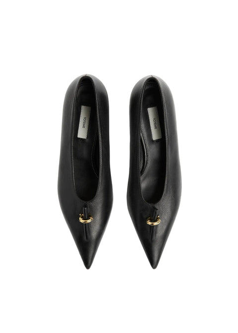 A pair of black leather pointed-toe pumps with a small gold detail on the vamp, photographed from directly above on a white background.