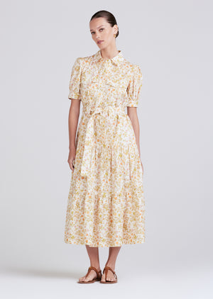 Full body shot of model wearing the buffy midi dress in cream multi with waisted belt detail.