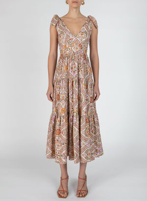 Model wears the timothea shoulder tie midi dress in multi colored print.