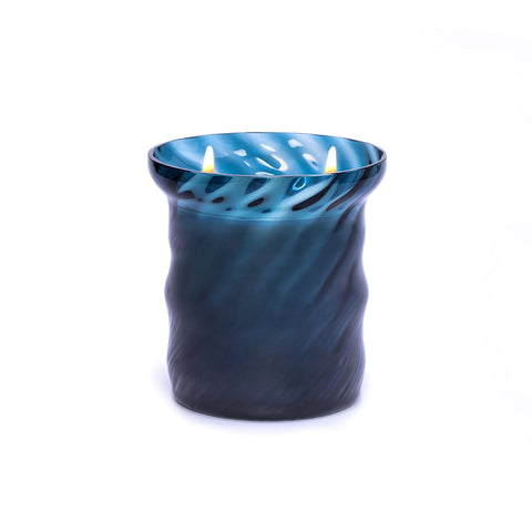 Lit blue murano glass candle.