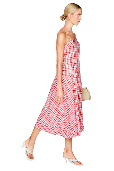 Woman wearing a red and white checkered dress on a white background