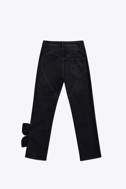 Back of black straight leg jeans with heart detail on the butt on a white background.