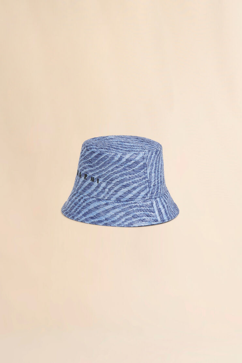 Blue striped raffia like bucket hat on a beige background