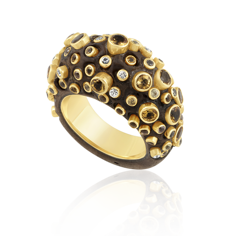 Carved walnut ring embedded stones on a white background