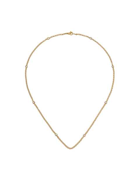 Gold necklace on a light beige background