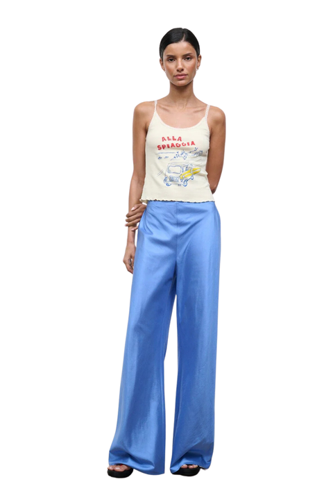 A woman wearing bright blue silk trousers