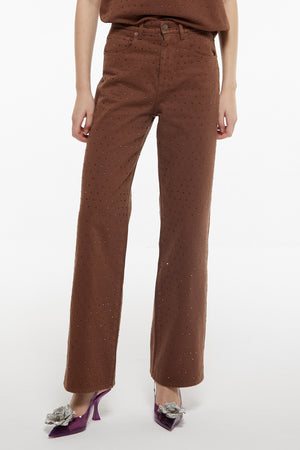 Up close of model wearing Giuseppe brown denim with crystals