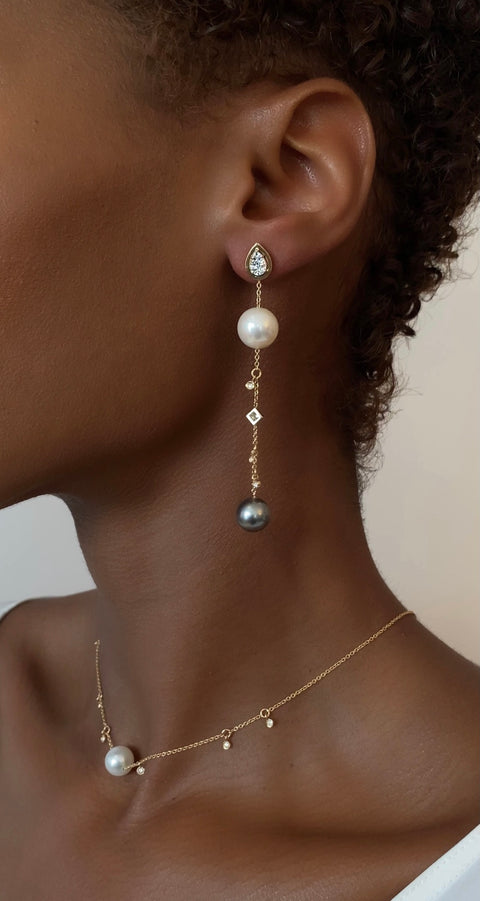 Model wearing the Catena Pearl Drop Earrings, showing how they look on a body.