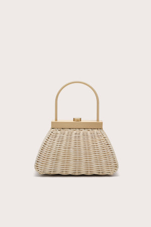 A trapezoidal woven handbag with a top handle. 
