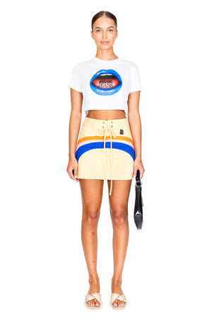 Model facing camera in the hi-tide mini skirt with blue and orange stripe.