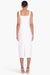Model facing the back in the white midi dress