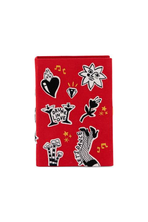 A red fabric book clutch featuring a black, white, and yellow graphic print with various rock and roll motifs including a heart, star, diamond, guitar, and the words 'DRYM LOVE' and 'FESS DANCE'.