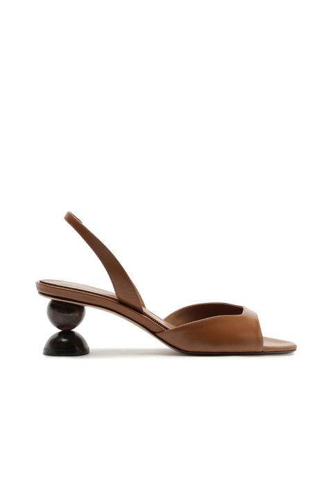 Brown sandal with a unique sphered black heel on a white background
