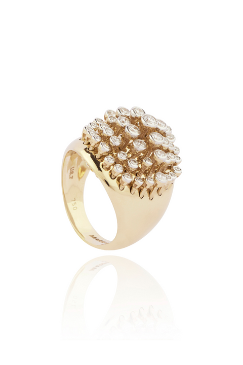 Gold ring with diamond cluster on a white background