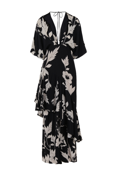 A black midi dress with a beige floral and leaf print, featuring a wrap-style V-neckline with tie details, short sleeves, and an asymmetrical ruffled hem, shown against a plain white background.
