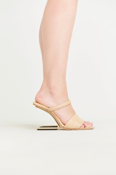 Side view of a raffia heel that features two over-the-foot straps and a gold-toned hollow, suspended heel. 