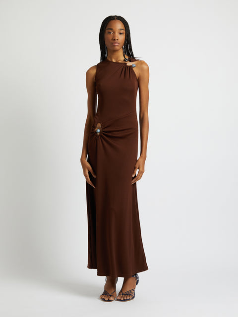 Model posing in the brown maxi dress.