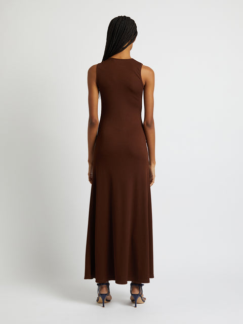 Model facing away showing the back of the maxi dress in brown.