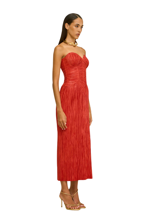 Woman wearing a strapless red dress side angle