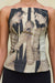Detail shot of a woman wearing a strapless bustier top with a sculptural neckline that features a black and tan portrait print depicting two women facing each other and holding an apple. 