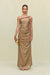 Woman wearing a gold metallic gown that features a hand rolled, one-shoulder neckline and intricate ruched draping throughout the body, paired with gold heels and accessories. 