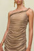 Close up of a woman wearing a gold metallic gown that features a plush, hand-rolled, one-shoulder neckline and draped ruching throughout the body. 