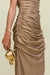 Detail shot of a gold metallic gown that features ruched draping throughout the midsection, paired with a gold rose shaped purse. 