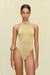 Woman wearing a metallic gold knit bodysuit that features a high neck and high cut leg, paired with a gold bangle. 