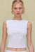 Close up of a woman wearing a white knit tank top that features corset-style ribbing. 