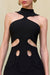 Detail shot of a woman wearing a black mini dress that features a high-neck detail and four side cutouts in the midriff. 