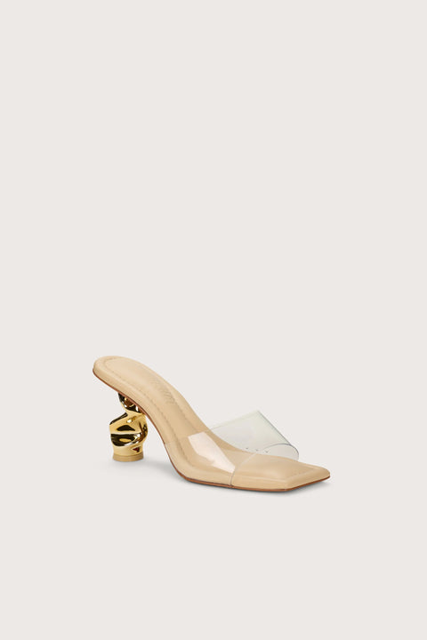 Front view of a square-to sandal with a clear vinyl strap and a sculptural gold heel. 