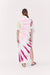 Woman showing back of tie-dye midi dress with side slit.