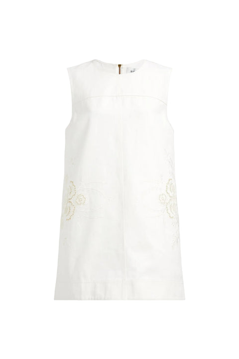 White sleeveless top with lace details on a light gray background