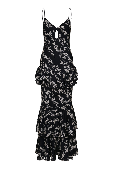 A black maxi-length ruffled dress with a white floral print, spaghetti straps, and a keyhole cutout at the neckline, shown against a plain white background.