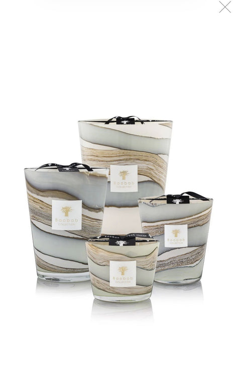 Set of three decorative candles with a brown and blue marble design on a white background