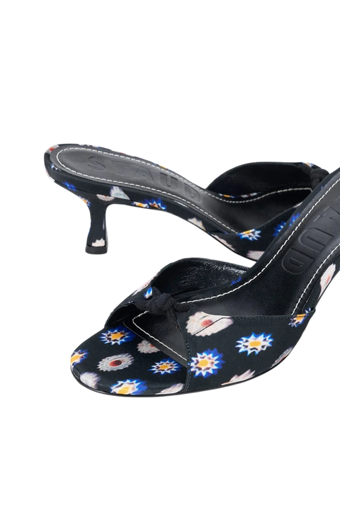 Black slingback kitten heel sandals with a colorful floral and daisy pattern, shown on a plain white background.