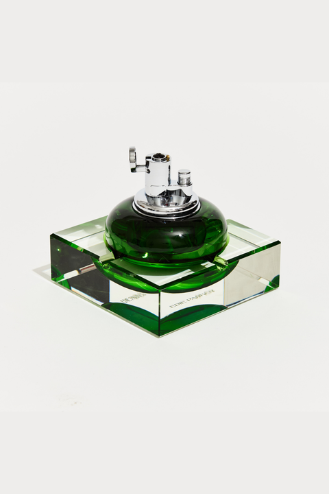 Green glass table top lighter with silver top on a white background