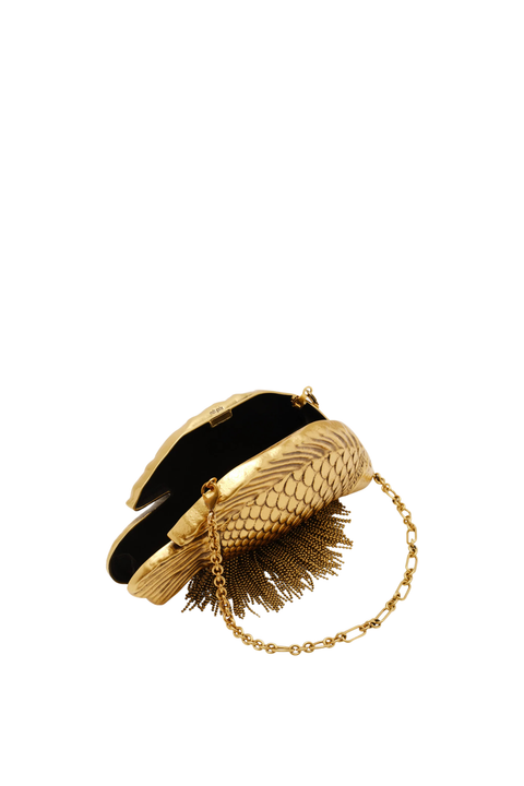 A gold metallic clutch purse with a textured, scale-like pattern, a black velvet interior lining, and a gold chain strap, shown on a plain white background.