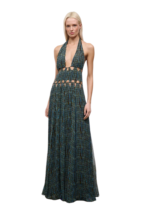 Woman wearing a blue and brown patterned halter neck maxi dress with cutouts