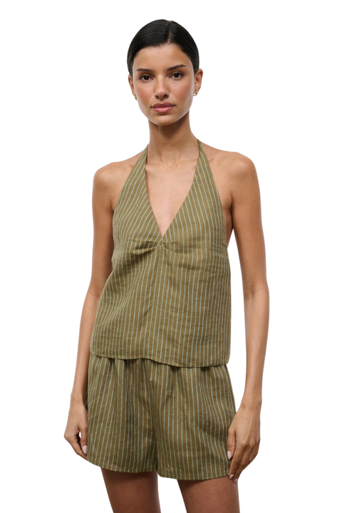 Woman wearing a green striped halter top and shorts set on a white background