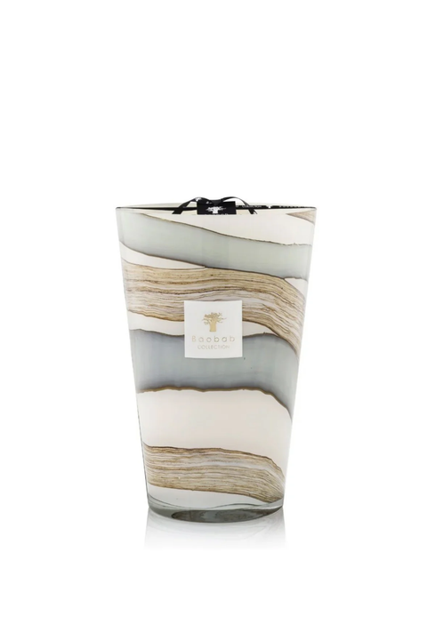 Large marbled patterned candle with a visible brand logo on a white background