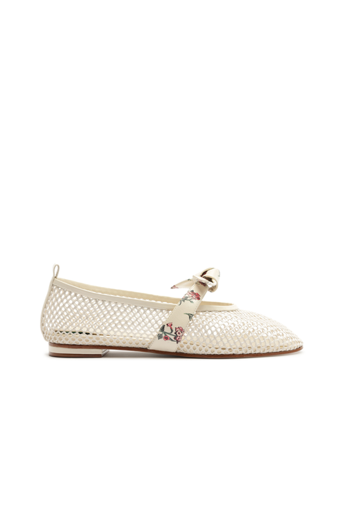 White netted flat shoe with a decorative bow and floral print on a white background