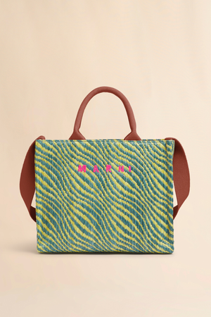 Handbag with a green and yellow striped pattern and pink text on a beige background
