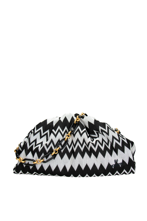 Black and white zigzag patterned clutch bag with gold chain on a white background