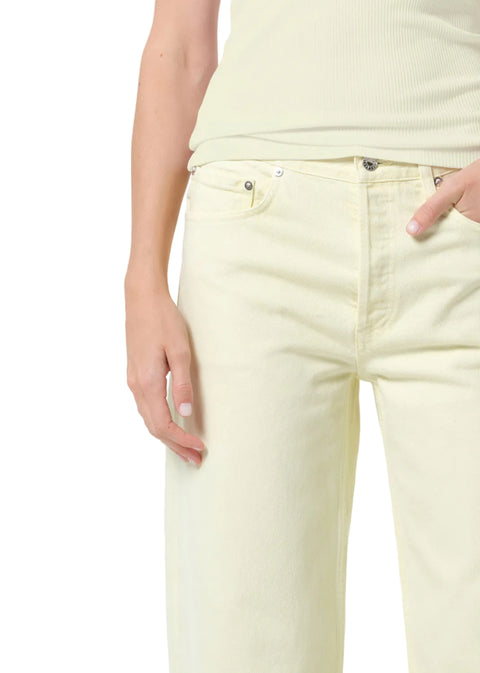 Person wearing a light green tank top and matching mid-rise, wide leg pants on a white background with hand in pocket zoomed in 