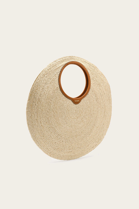Beige woven bag with brown handle on a beige background