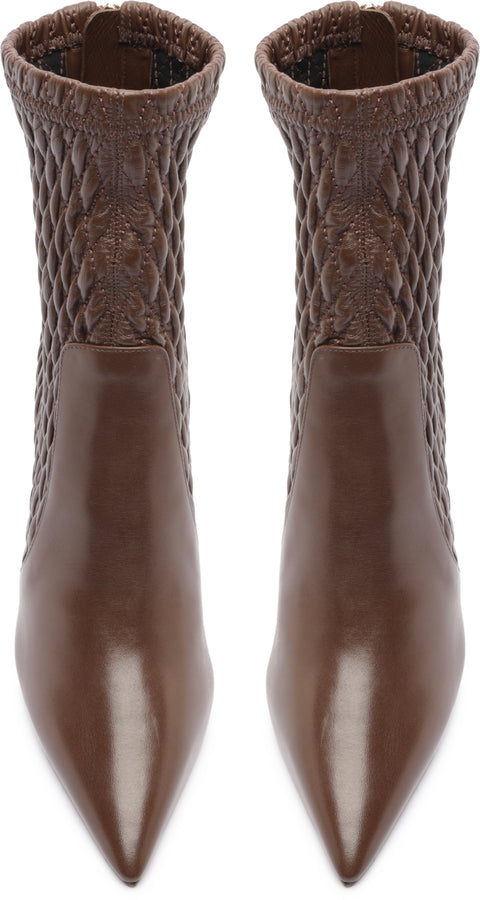 Pair of brown pointed-toe boots with textured knit top on a white background