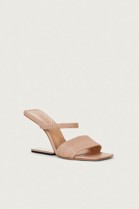 Front angle of a raffia heel that features two slide in straps and a gold-toned suspended, geometric heel. 